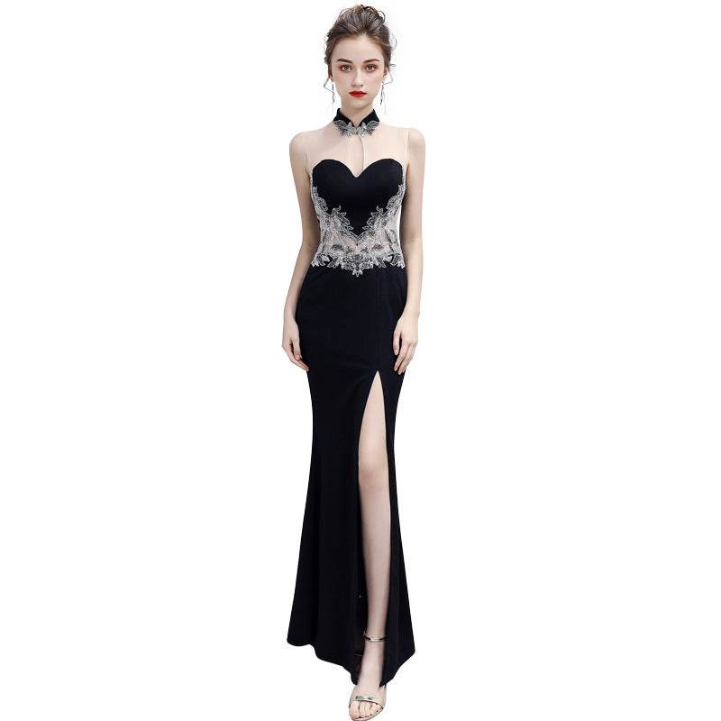 Elegant black evening dress with lace detail, sheer neckline, and thigh slit design