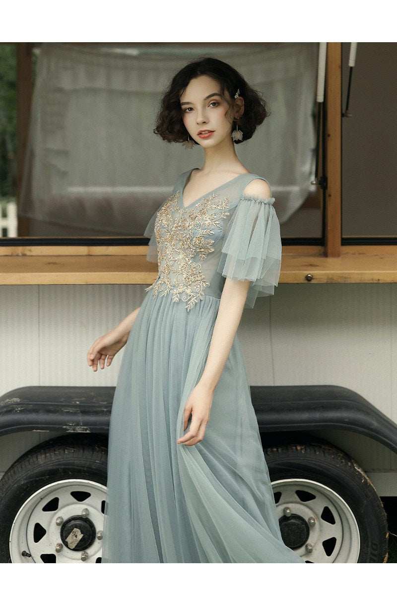 summer long-sleeved evening dress with intricate embroidery and flowing princess skirt in soft pastel color