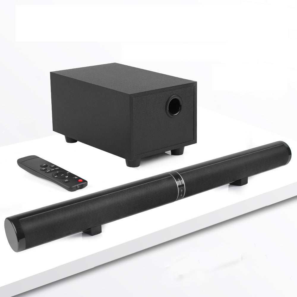 Home Theater TV subwoofer speaker system with remote, black subwoofer and soundbar on white surface