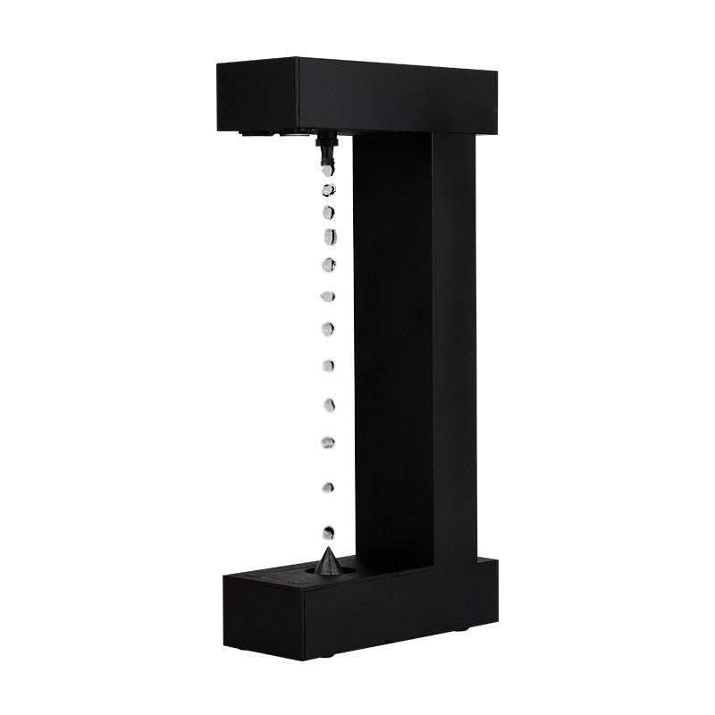 Black anti-gravity floating sand drop LED table lamp with modern geometric design and button switch