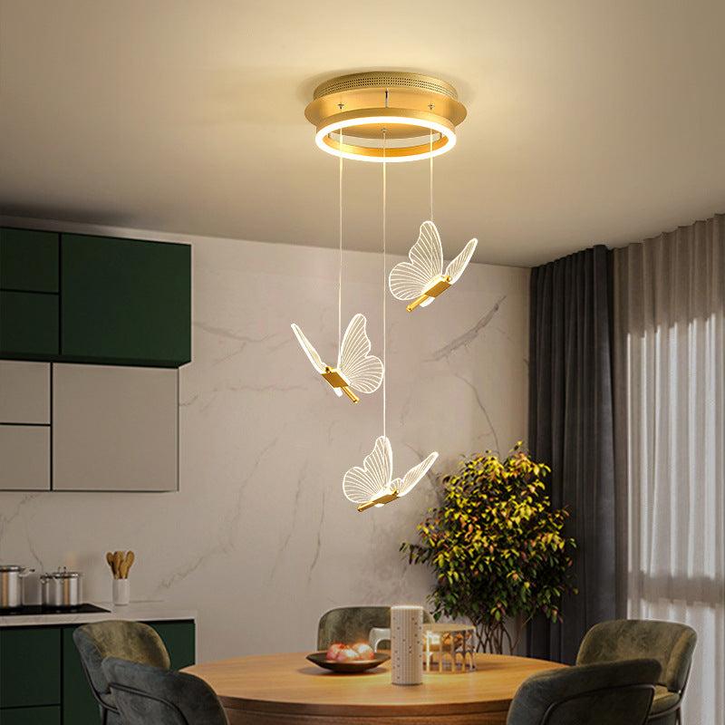 Modern living room loft chandelier with rotating butterfly-shaped LED lights hanging over dining table