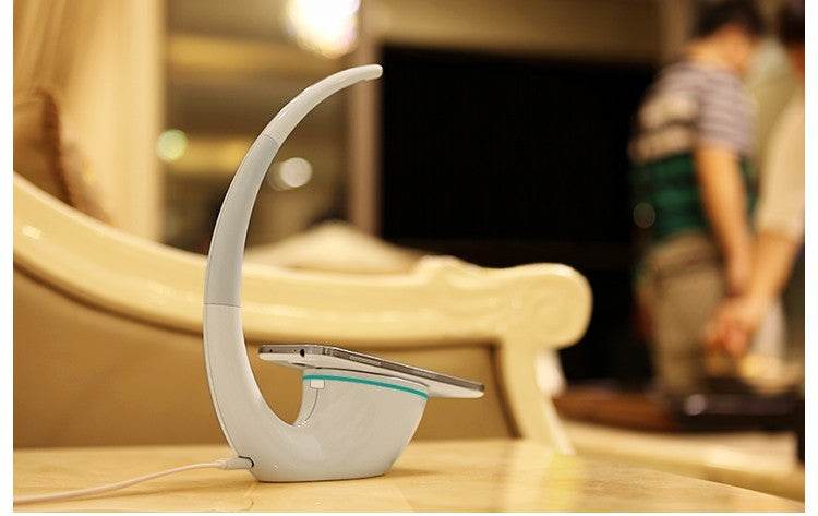 Modern Wireless Charger Phantom Table Lamp with curved design and touch dimming function on wooden table