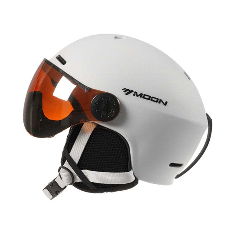 White Moon ski helmet with impact-resistant polycarbonate shell and integrated retractable orange sun visor