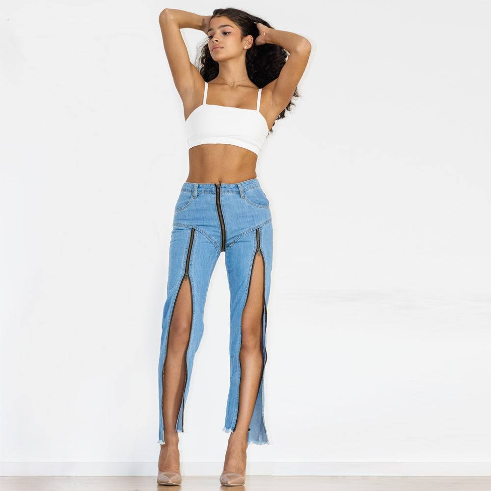 Woman wearing light blue denim split straight jeans with front zippers and high waist, paired with white crop top and heels.