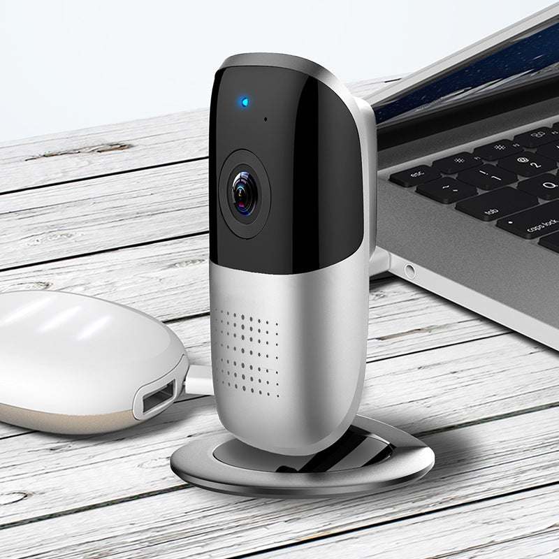 WiFi camera panoramic VR185 HD wireless network monitoring device on desk next to laptop