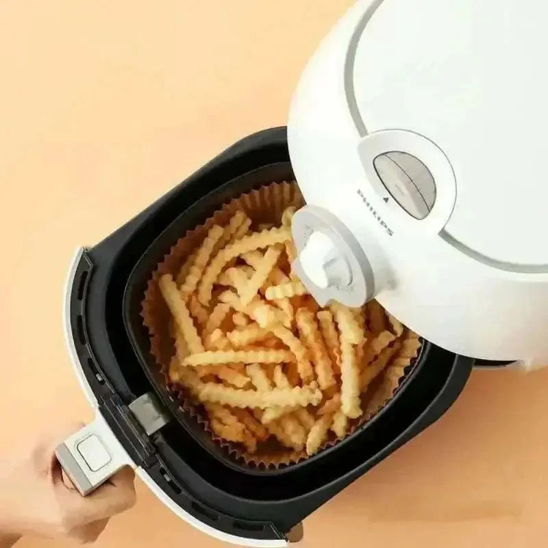 Air fryer with crinkle-cut fries on food-grade non-stick blotting paper liner