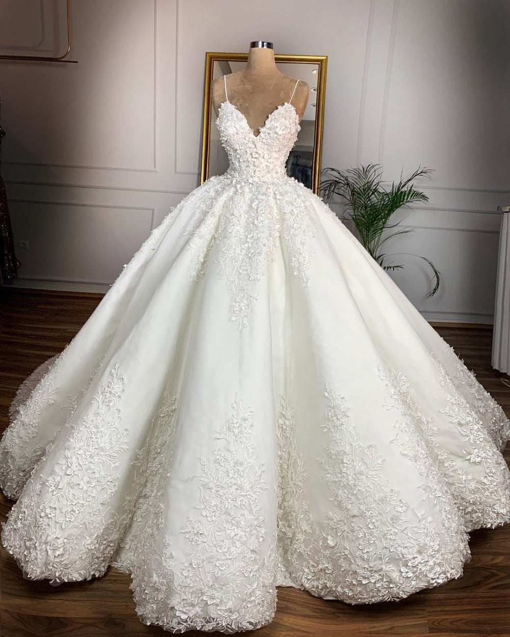 Deep V-neck white lace floor-length wedding dress with sleeveless straps and embroidered floral details