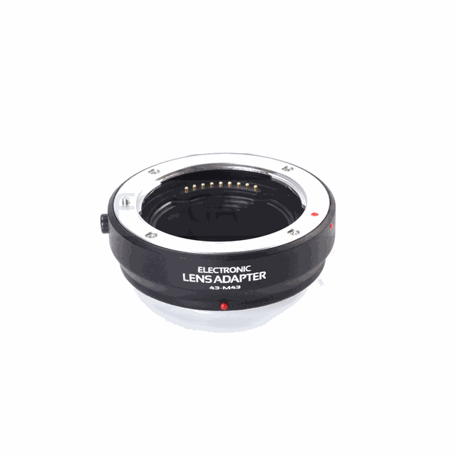 Electronic adapter ring for Olympus 4/3 lenses with metal bayonet and plastic body featuring electronic contacts for autofocus and adjustable aperture.