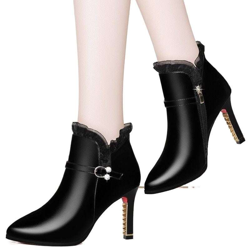 Black women's high heel ankle boots with stiletto heels and side zipper, featuring a decorative buckle and velvet trim.