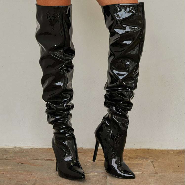 Black glossy knee high long boots for women with super high thin heels and pointed toes, stylish party shoes with side zipper closure.