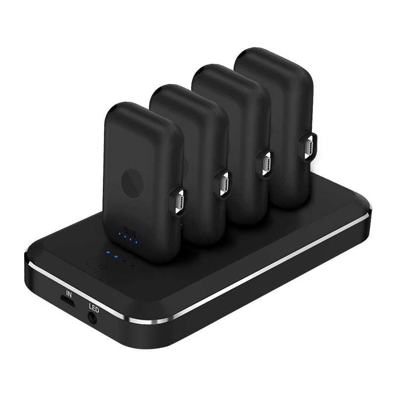 Black magnetic charging treasure mini capsule power bank with LED flashlight and multiple charging units on charging dock