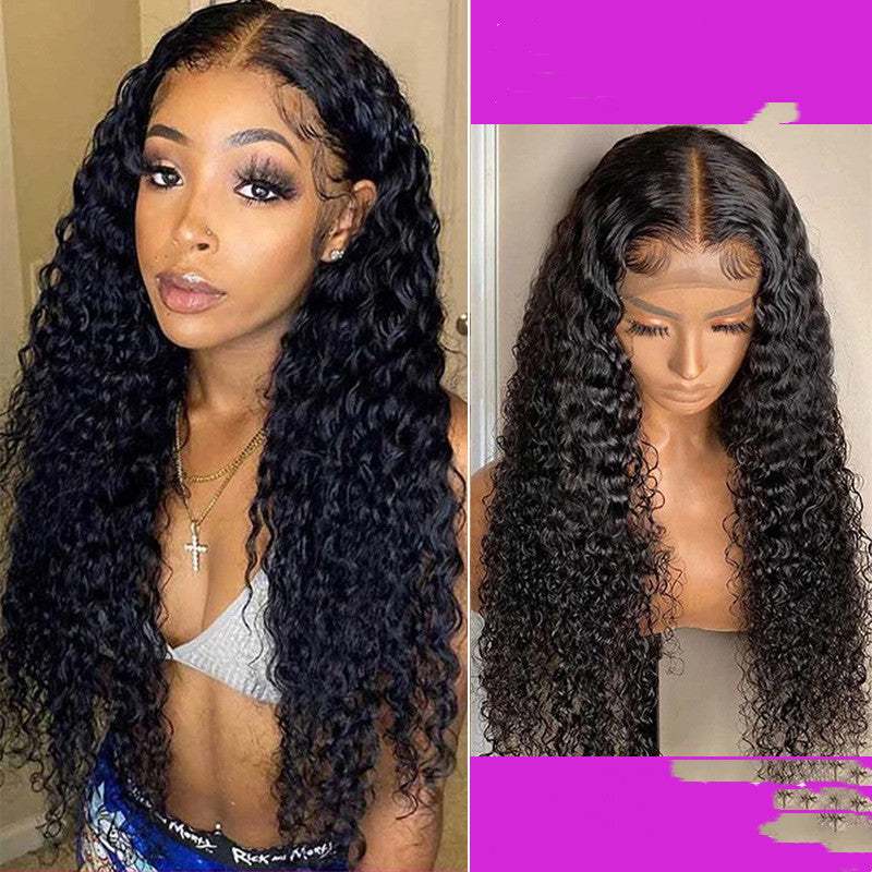 Woman wearing Manufactory Reality Wig with long curly black hair next to a mannequin head displaying the same wig