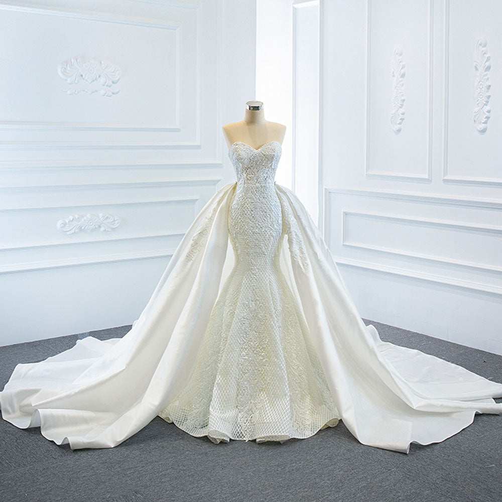 Elegant white fishtail wedding dress with strapless sweetheart neckline and long train on mannequin