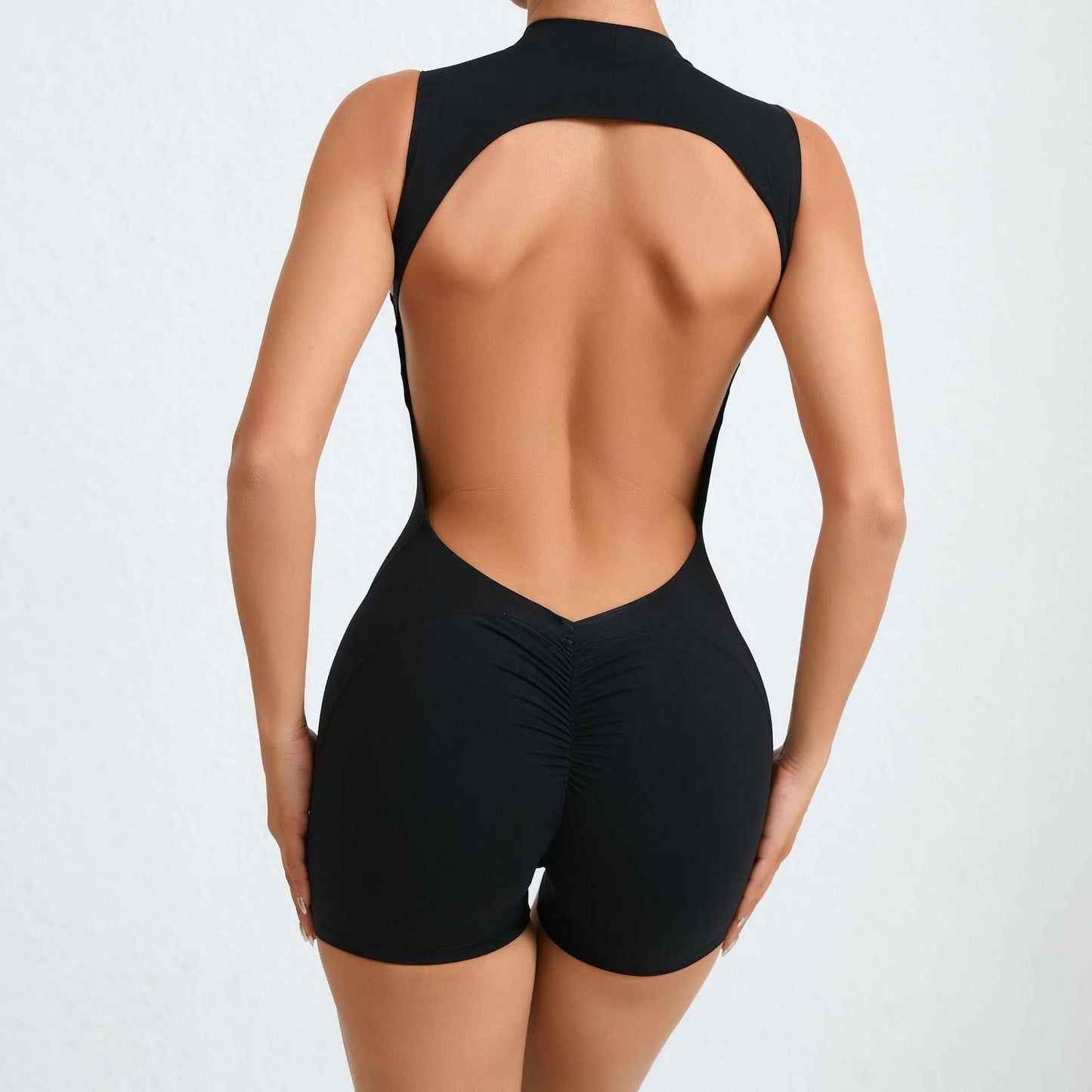 Woman wearing black sleeveless back hollow yoga jumpsuit for summer fitness and sports activities