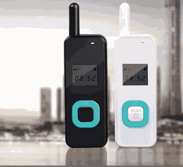 Two hanging ear mini walkie talkies in black and white with digital displays and teal buttons
