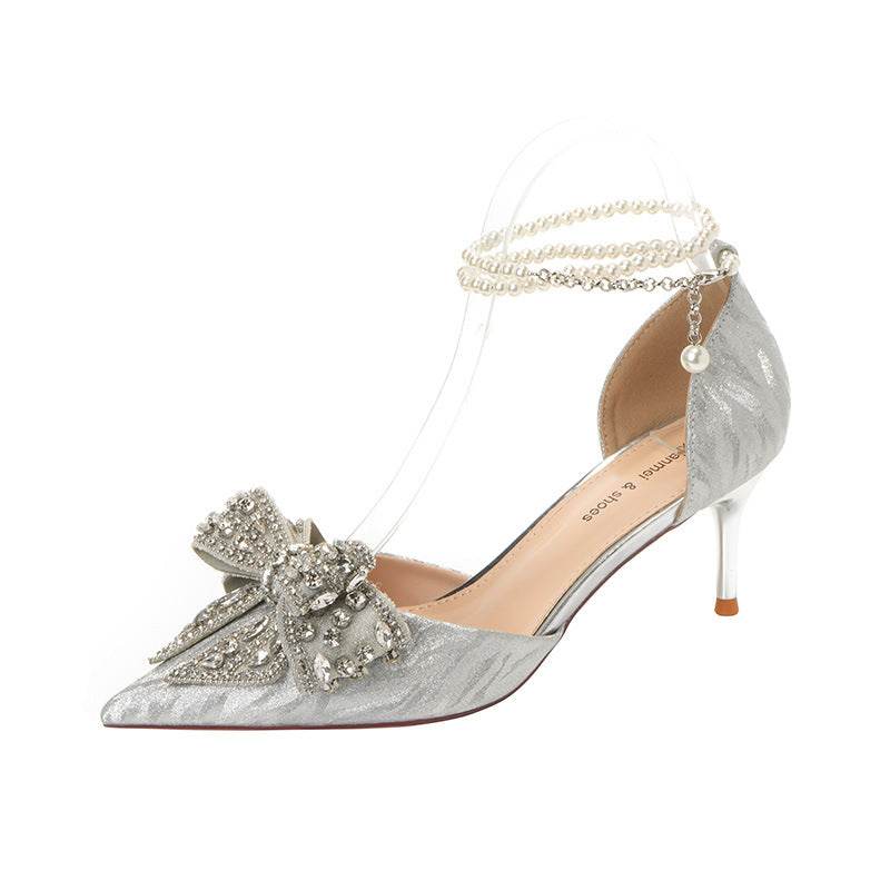 Silver rhinestone bow pointy high heel with pearl ankle strap and microfiber upper