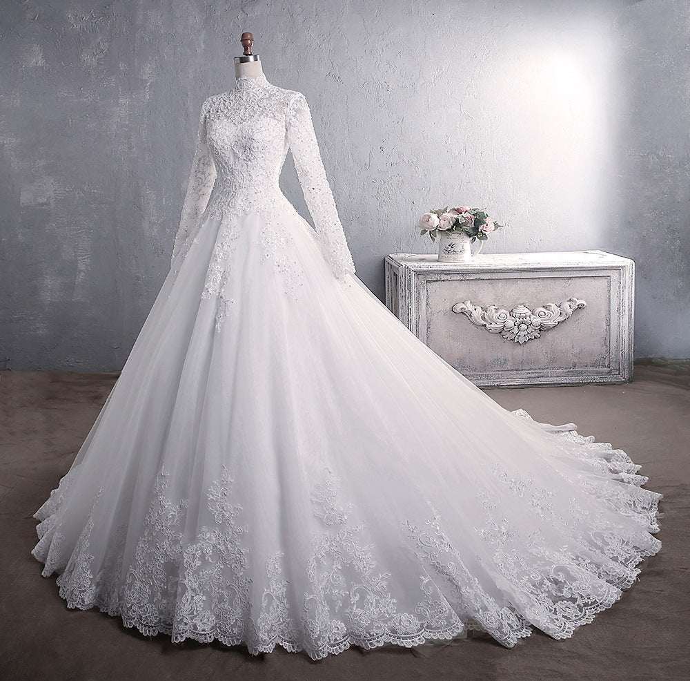 White lace wedding dress with stand-up collar, long sleeves, and large tail on mannequin