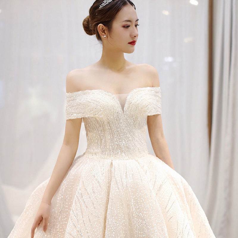 Elegant white dreamy word shoulder wedding dress with long tail and lace fabric detailing