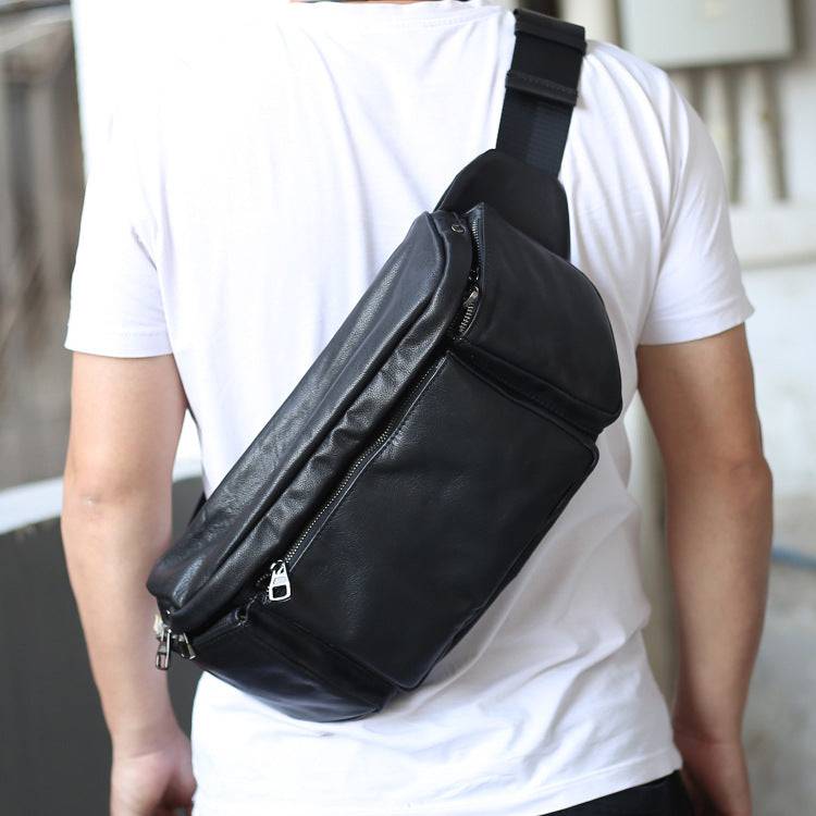 Black cowhide large capacity single shoulder messenger bag worn crossbody with zipper closure