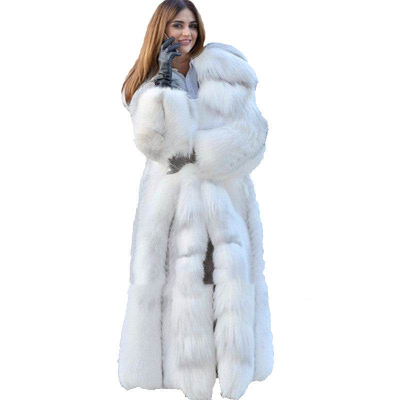 Woman wearing a white long style artificial fur coat with hood and black gloves