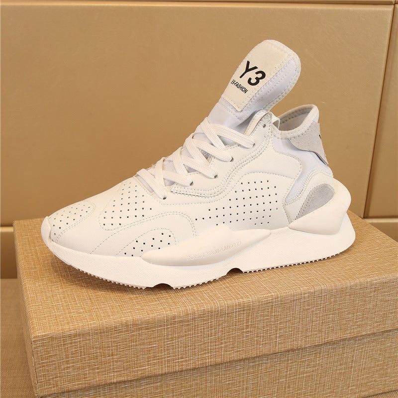 White men's casual leather running sneaker with breathable perforated design and front lace-up on brown box