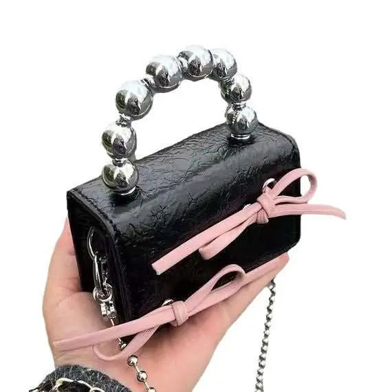Textured Cute Bow Mini Chain Handbag - AMIR BAGS INDIA PRIVATE LIMITED