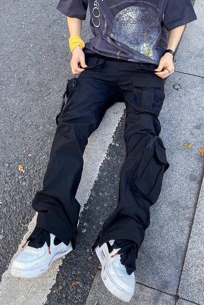 Black hip hop style overalls trousers for men with zipper and cargo pockets, casual fit and straight legs.