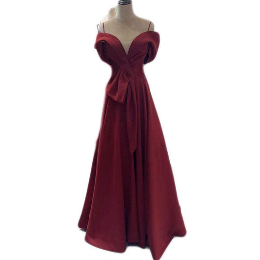 Red off-shoulder evening gown with a one-line collar and flowing skirt