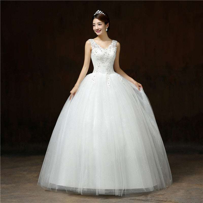 Elegant white wedding dress with a fitted embellished bodice and a voluminous tulle skirt