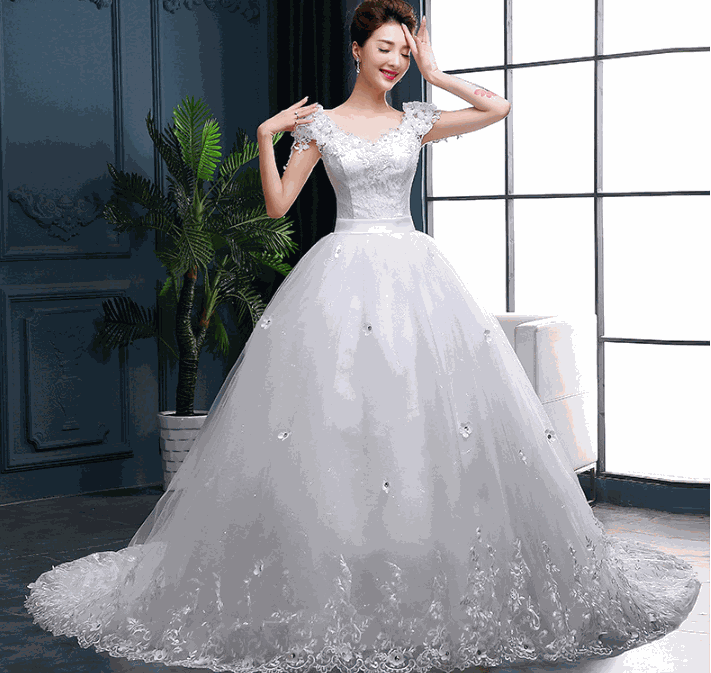 Elegant long tail white wedding dress with lace bodice and floral details in silk mulberry fabric