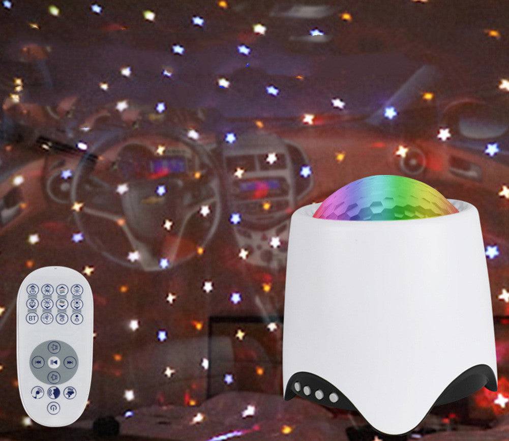 Night light projector with remote control displaying colorful star patterns and ocean wave effects.