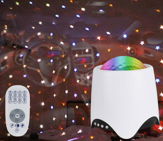 Night light projector with remote control displaying colorful star patterns and ocean wave effects.