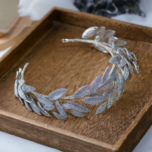 Silver artificial zircon alloy hair band with leaf design on wooden tray