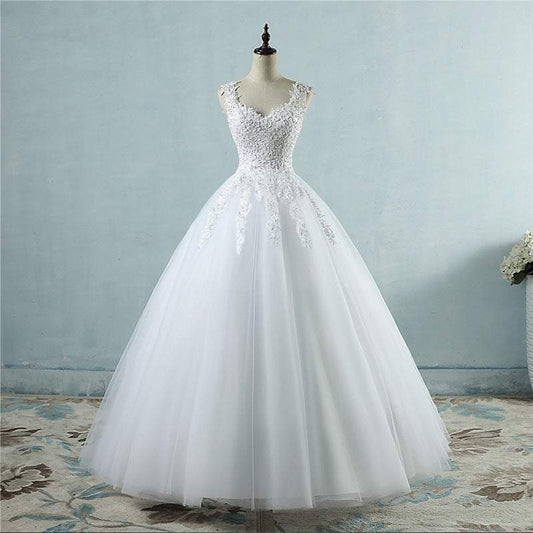 White high waist wedding dress with lace bodice and full tulle skirt on mannequin
