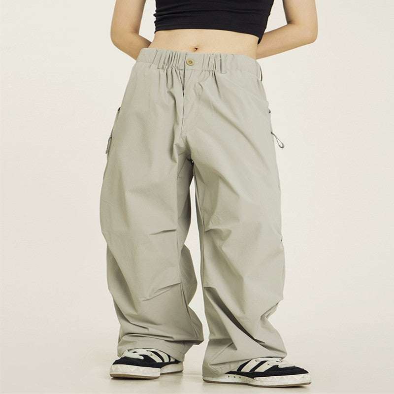 Vintage pleated parachute cargo pants in beige, loose fit with straight legs and mid waist design.